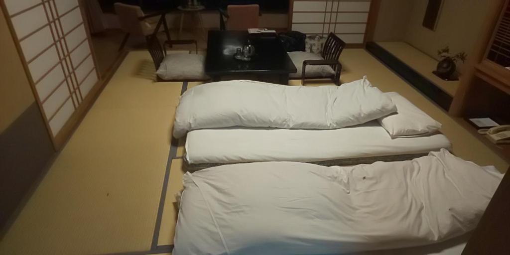 Postel nebo postele na pokoji v ubytování Atagawakan