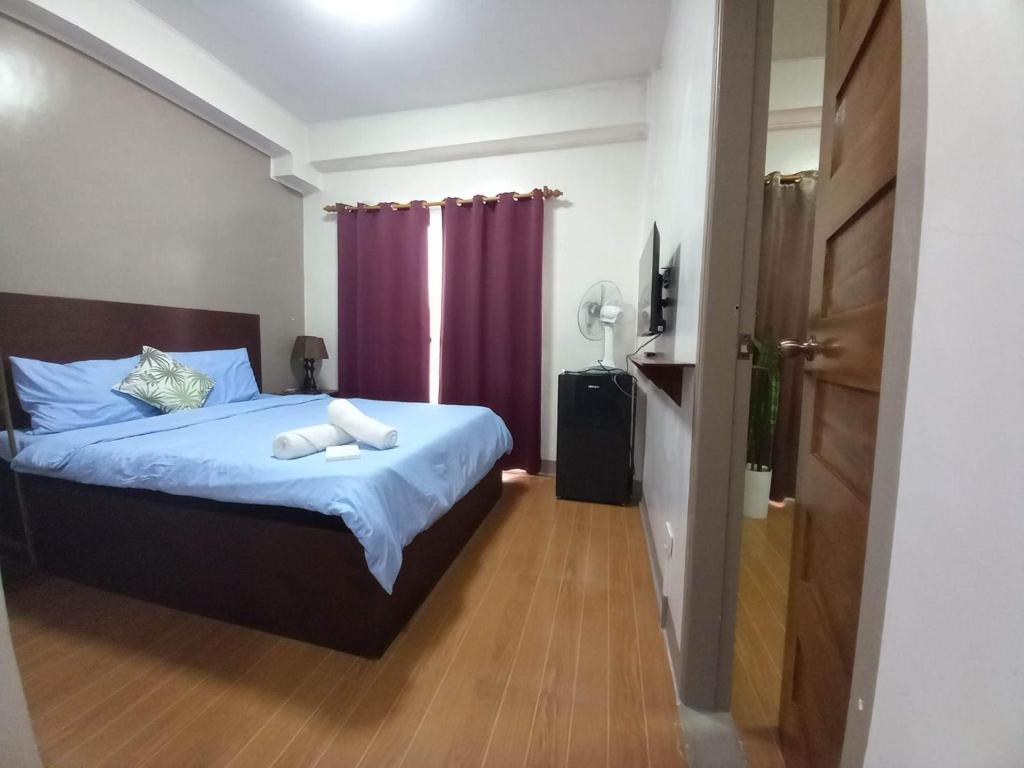 Postel nebo postele na pokoji v ubytování CASA LA EL BAGUIO