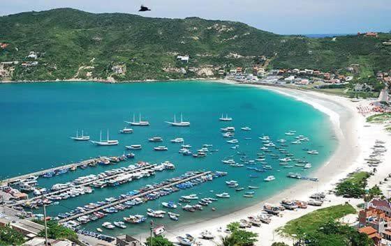 an aerial view of a harbor with boats in the water at Casa de Praia in Arraial do Cabo