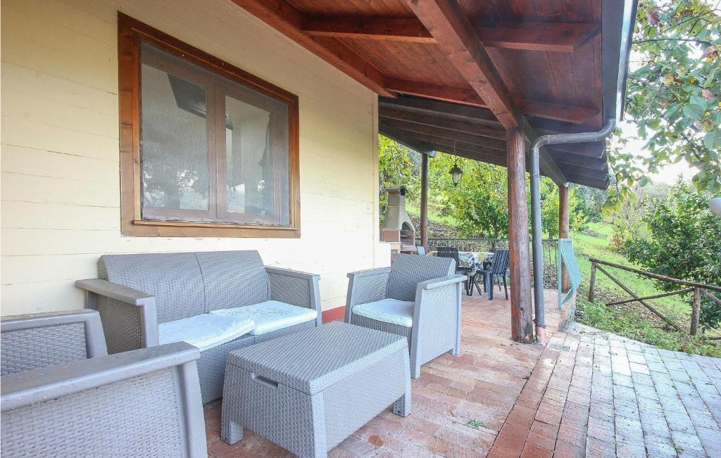a patio with chairs and a table and a window at Pet Friendly Home In Stella Cilento With House A Panoramic View in Stella Cilento