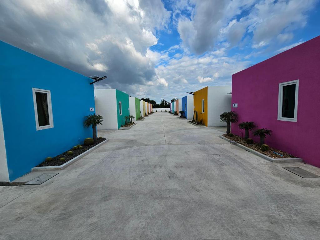 a row of colorful houses on a street at Klong Zand Resort in Rayong