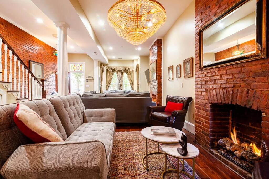 a living room with a couch and a fireplace at Little Persian Palace with Parking in Washington, D.C.