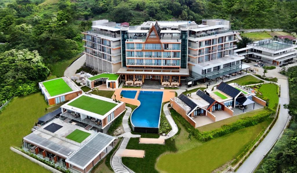 an aerial view of a building with a swimming pool at Marianna Resort & Convention Tuktuk Samosir in Ronggurnihuta