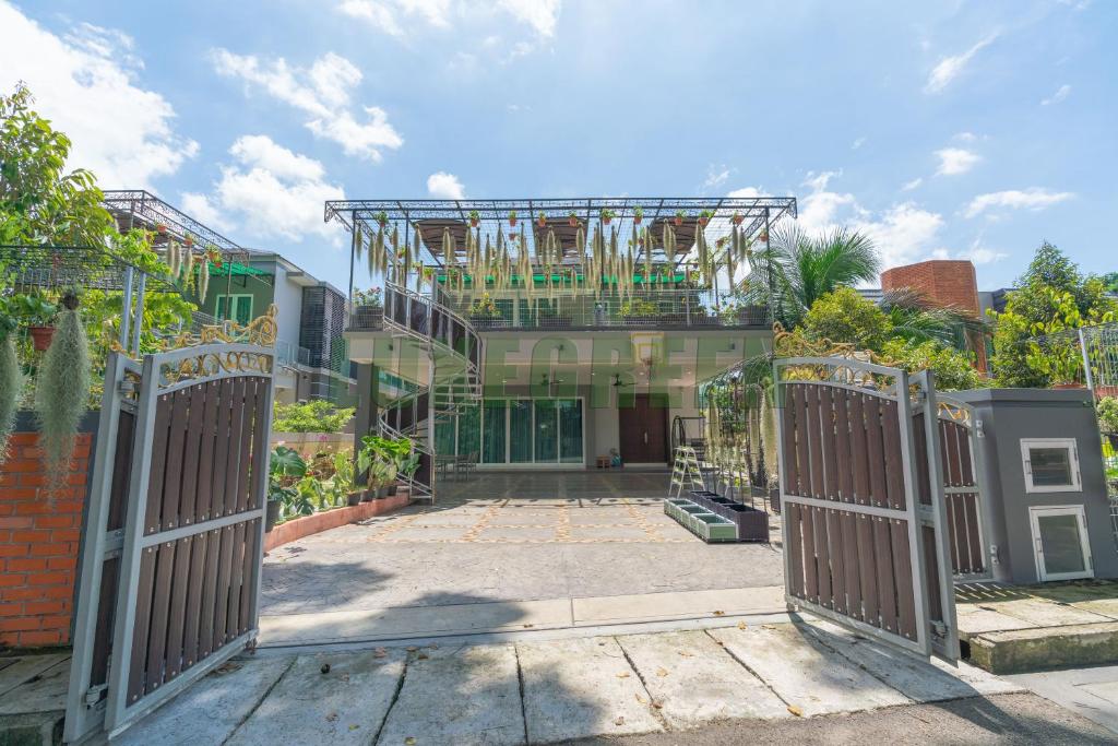 an open gate in front of a building at LuxegreenRetreat , Bungalow - Georgetown, Penang in George Town