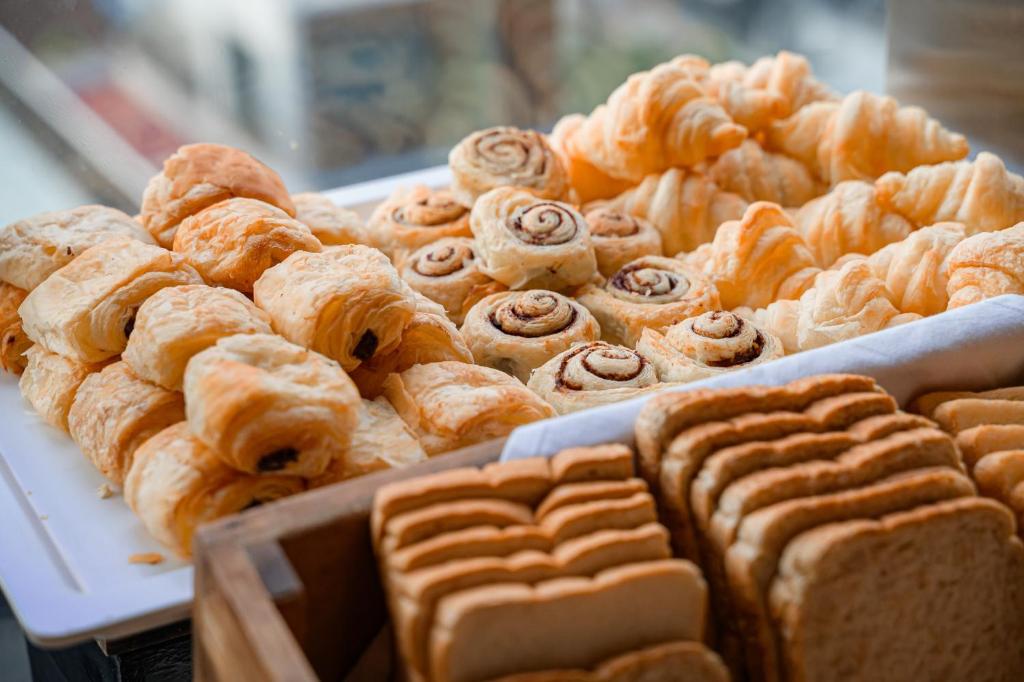 a bunch of pastries on display in a bakery at Hotel Clover Asoke - SHA Extra Plus in Bangkok