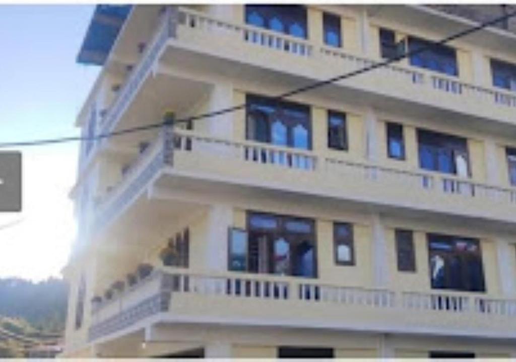 a tall building with balconies on the side of it at TK Residency Arunachal Pradesh in Tawang