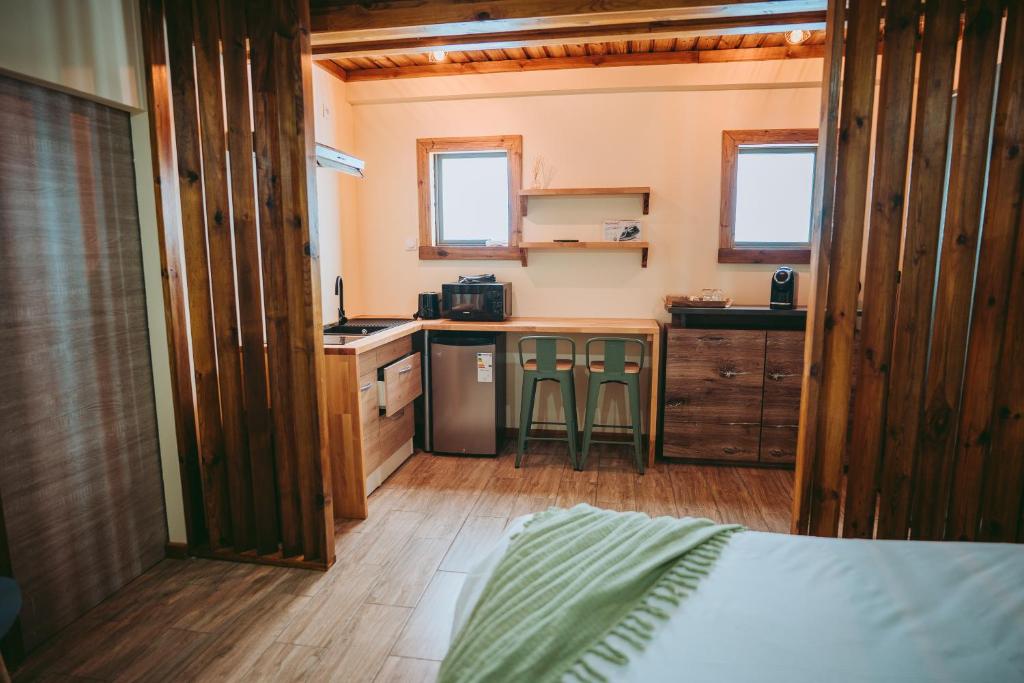eine kleine Küche mit einem Bett in einem Zimmer in der Unterkunft L'Auberge Créole in Saint-Benoît