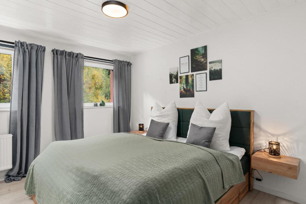 a bedroom with a bed with gray and white pillows at EasyGoing Switch Streaming schönes Apartment 6 Personen in Arnsberg