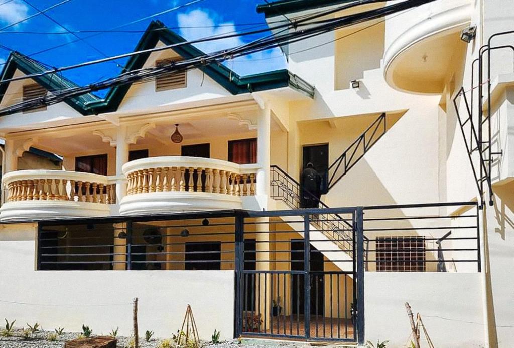 una casa blanca con una escalera delante en RedDoorz @ The Central Inn Boracay Island en Boracay