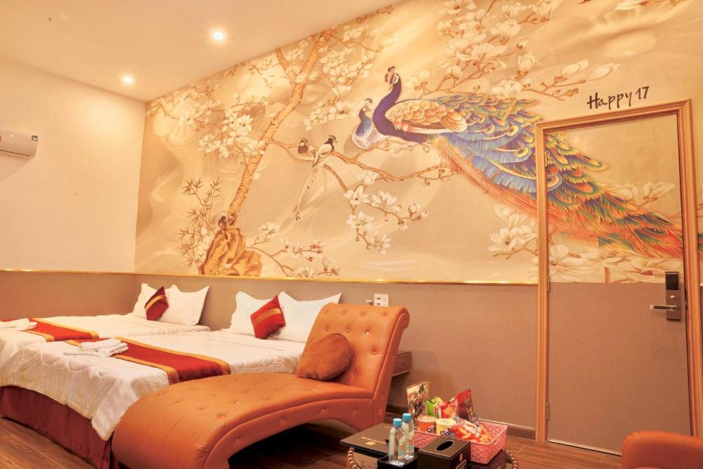 a bedroom with a bed with a peacock painting on the wall at Hoàng Tây Hotel - Đồng Tháp in Ấp Hòa Lạc