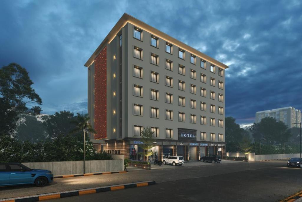 een weergave van een gebouw met auto's geparkeerd op een parkeerplaats bij The Sky Imperial Hotel Kailash in Jamnagar