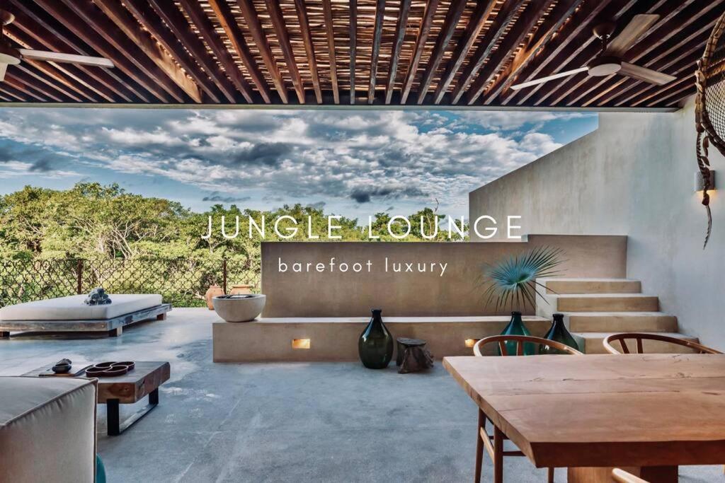 图卢姆Jungle Lounge Barefoot Luxury 3BR Two Level Penthouse with Pool in Luum Zama的一座建筑,上面标有读丛林之旅的标志,豪华的酒吧