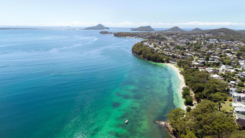 an aerial view of the ocean and a beach at Dutchies Motel Nelson Bay & Dutchmans Beach Apartments in Nelson Bay
