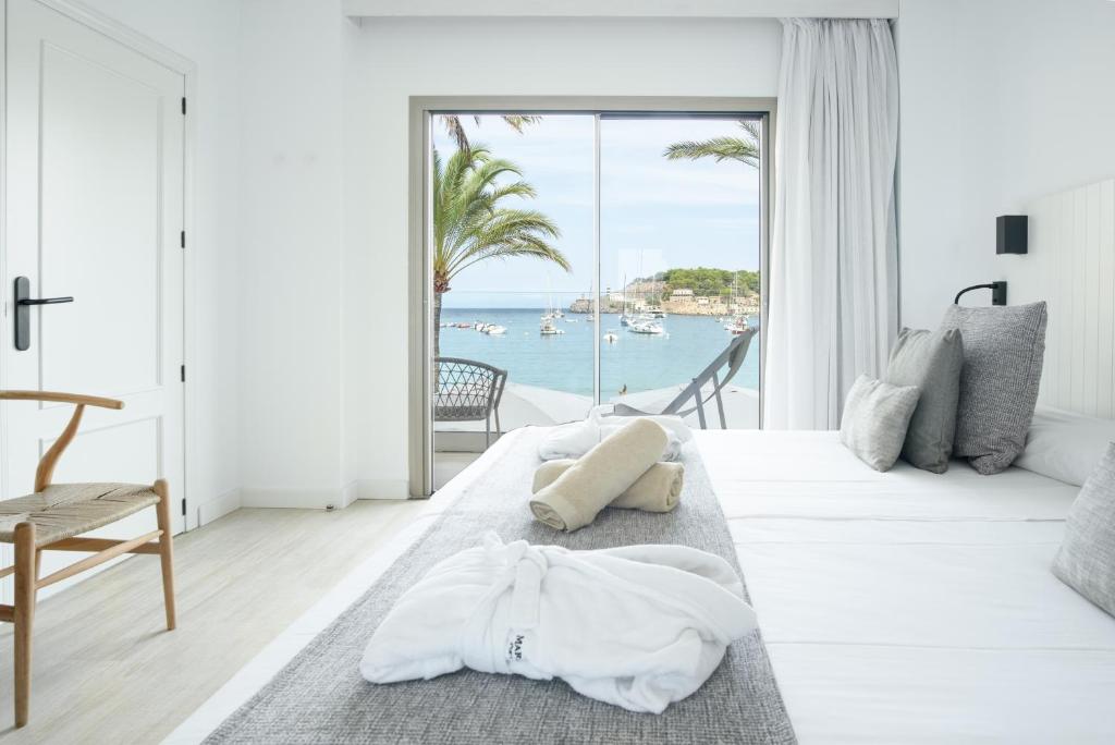 a white living room with a view of the ocean at Hotel Marina in Port de Soller