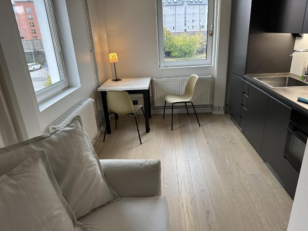 a living room with a couch and a table and two chairs at Apartment in Sollentuna Centrum 1205 in Sollentuna