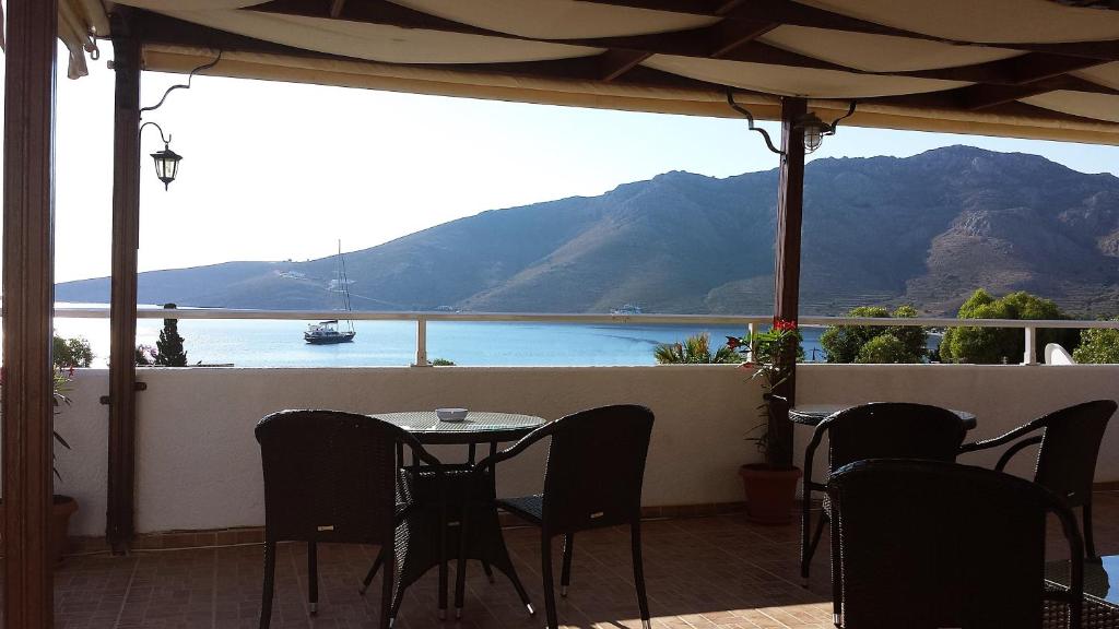 a patio with a table and chairs and a view of the water at Apollo Studios in Livadia