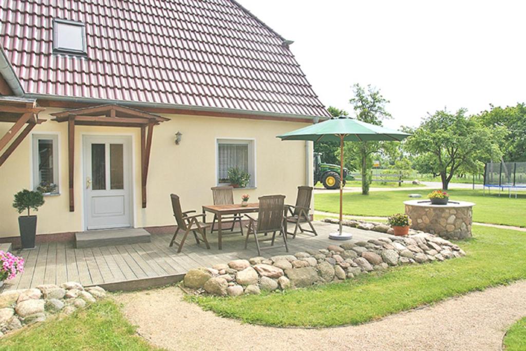 un patio con un tavolo e un ombrellone di Ferienhof Willi a Stilow
