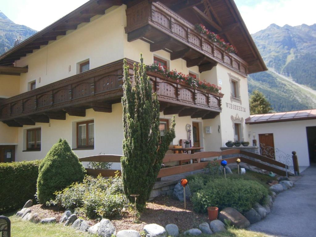 a building with a balcony on the side of it at Haus Wiesenheim FW Ötztal in Längenfeld