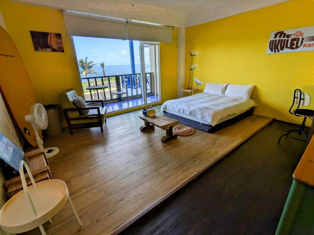 a bedroom with a bed and a view of the ocean at Blackport Seaview Homestay in Yanliau