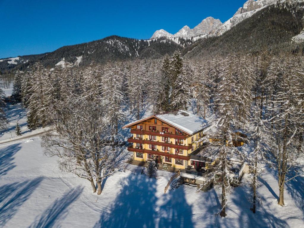 an aerial view of a house in the snow at Hotel Rösslhof in Ramsau am Dachstein