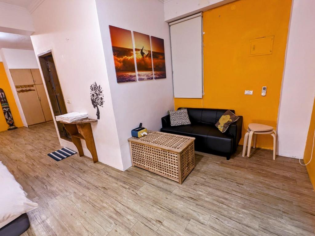 a living room with a couch and a table at Blackport Seaview Homestay in Yanliau