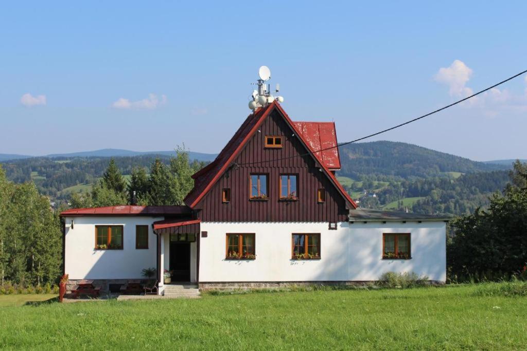 a large white house with a red roof at Holiday Home Jizerka in Nova Ves nad Nisou