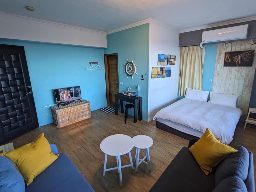 a living room with a couch and a table at Blackport Seaview Homestay in Yanliau