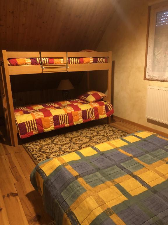 two bunk beds sitting next to each other in a room at Maison Sur 2 Niveaux in Nance