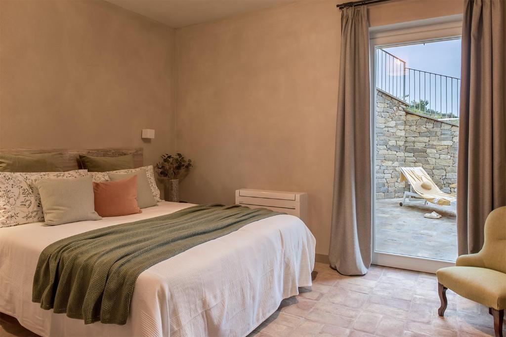 1 dormitorio con 1 cama y puerta corredera de cristal en I Ciabot di Monforte, en Monforte dʼAlba