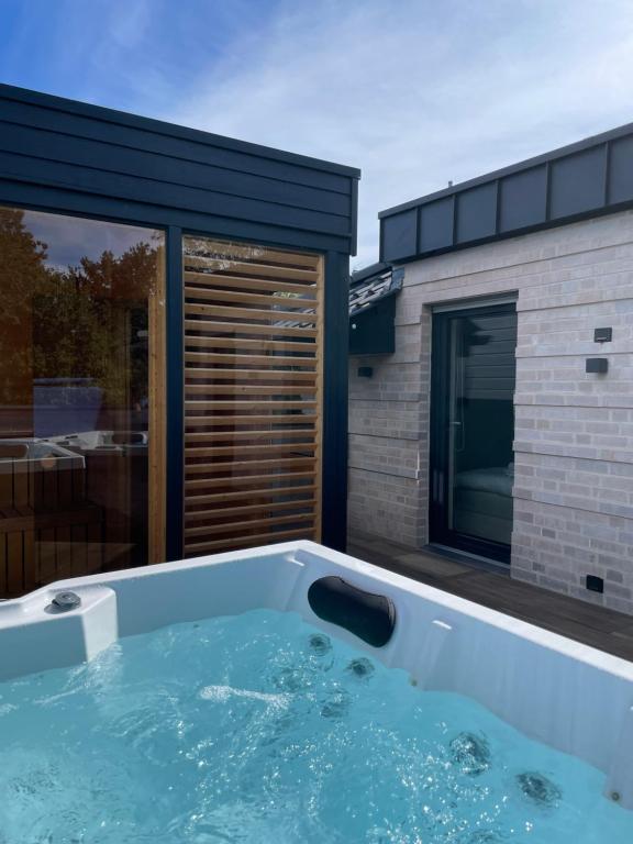 a jacuzzi tub in front of a house at My Baltic Sea - Ferienwohnungen im Seaside House in Scharbeutz