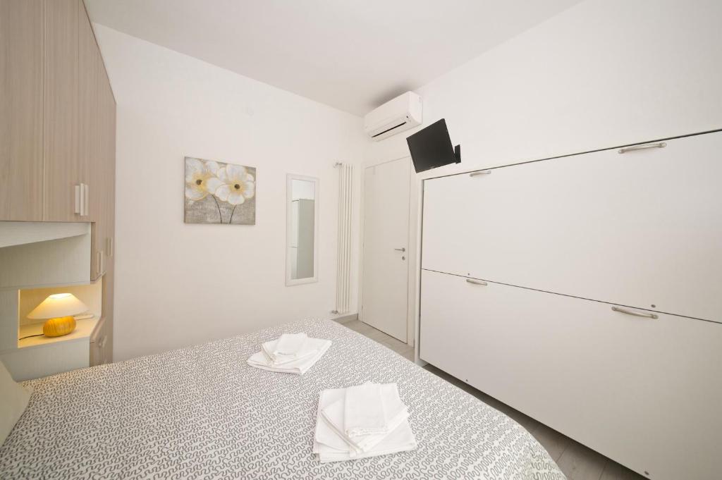Posteľ alebo postele v izbe v ubytovaní Fornaci 9 RivieraHoliday