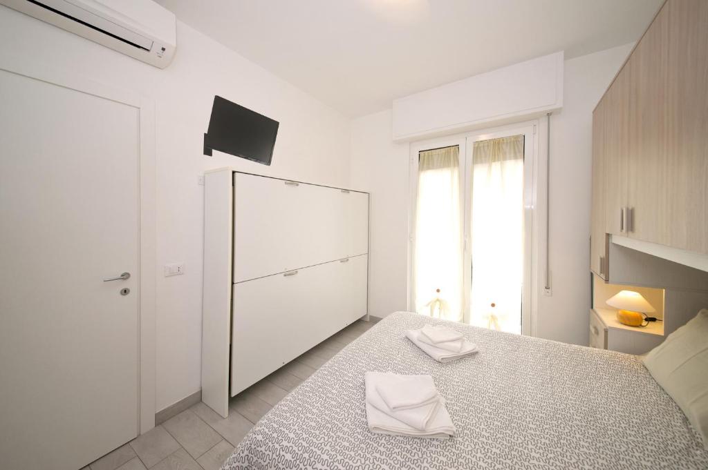 Posteľ alebo postele v izbe v ubytovaní Fornaci 9 RivieraHoliday