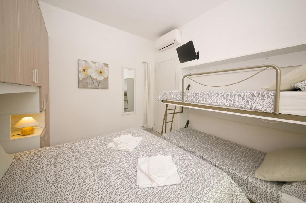Posteľ alebo postele v izbe v ubytovaní Fornaci 9 RivieraHoliday