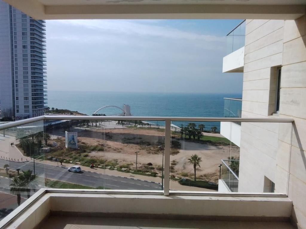 a balcony with a view of the ocean at מול החוף במלון רמדה נתניה in Netanya