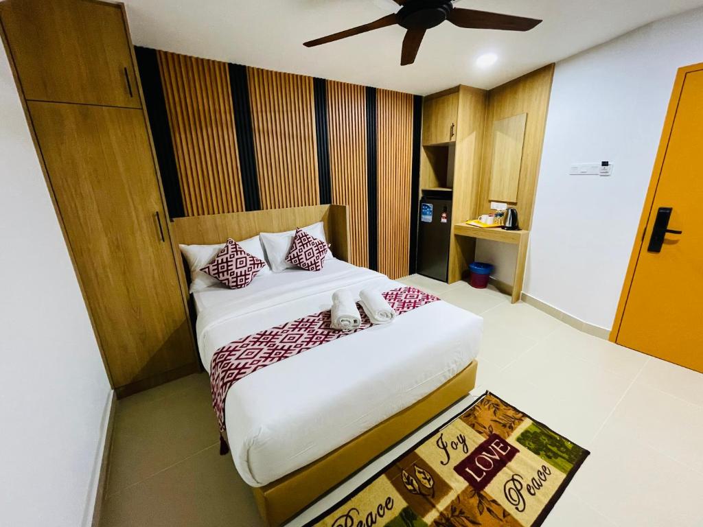 A compact double bedroom with a ceiling fan, work surface and storage.