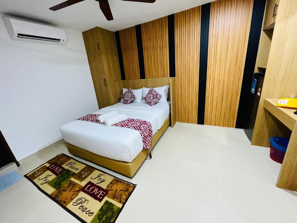 A compact bedroom with two single beds, air conditioning and built-in storage.