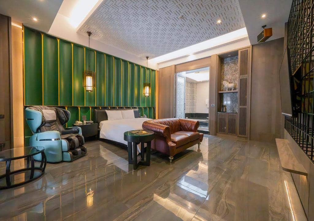 Cette chambre comprend un lit et un mur vert. dans l'établissement Feng Cai Motel, à Yuanlin
