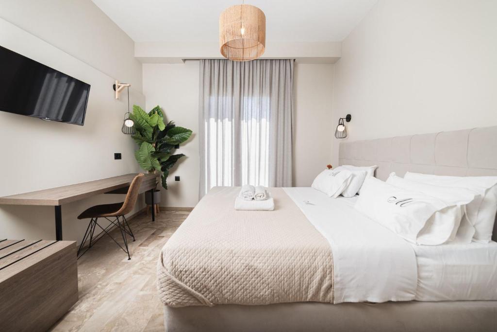 Postel nebo postele na pokoji v ubytování Manthos Beachfront Apartments