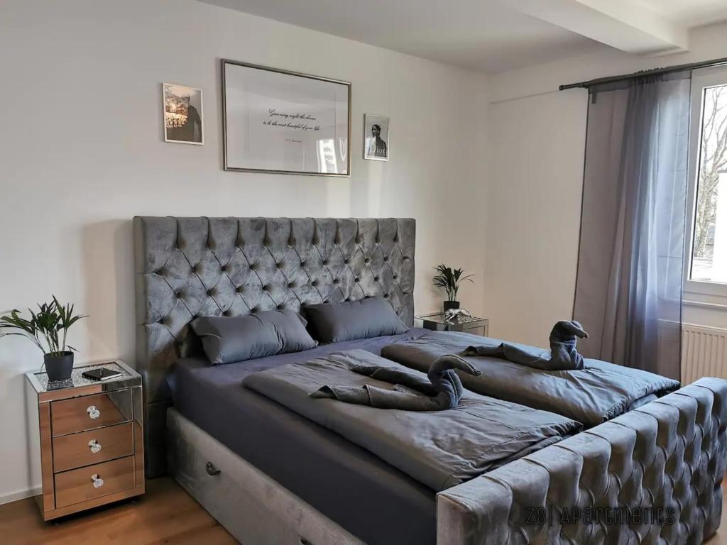 a bedroom with a large bed with a large headboard at Z8 Living in Hannover