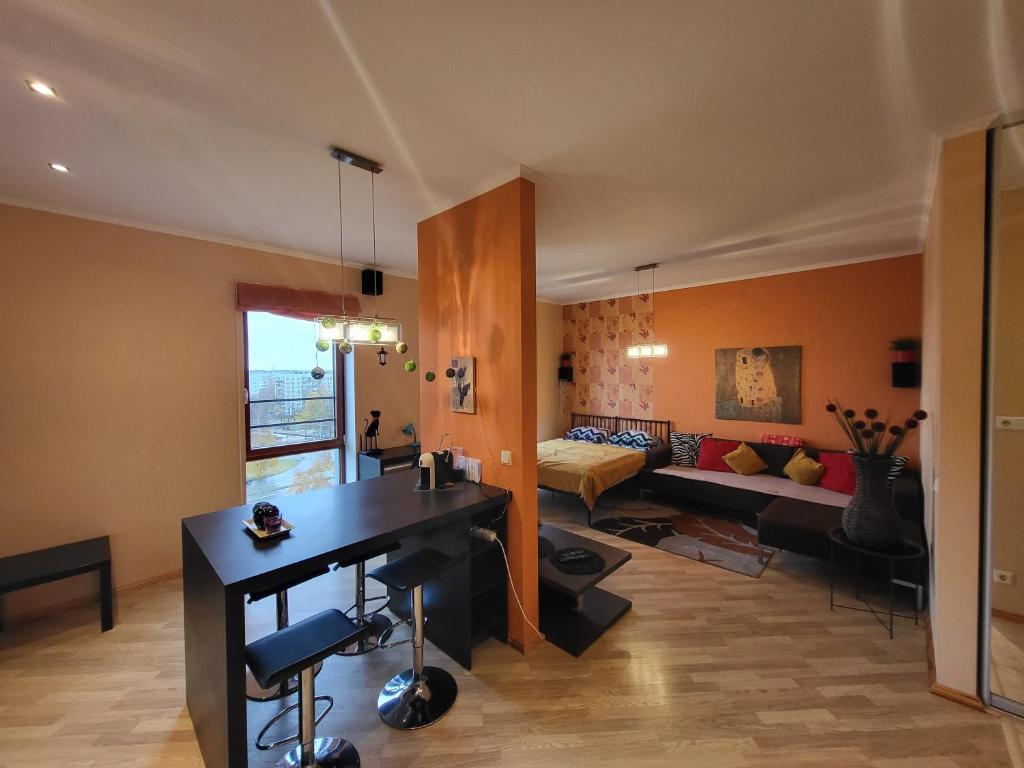 een woonkamer met een tafel en een bank bij Solaris Studio Apartments in Rīga