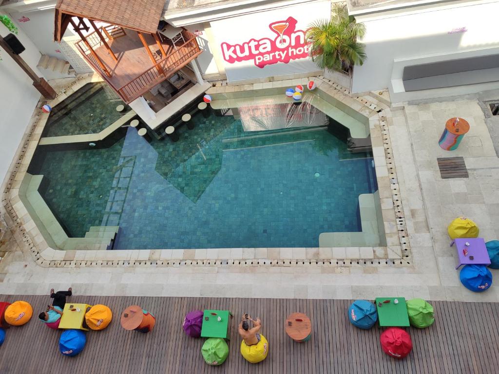 an overhead view of a swimming pool with colorful chairs at Kuta One Party Hotel in Kuta