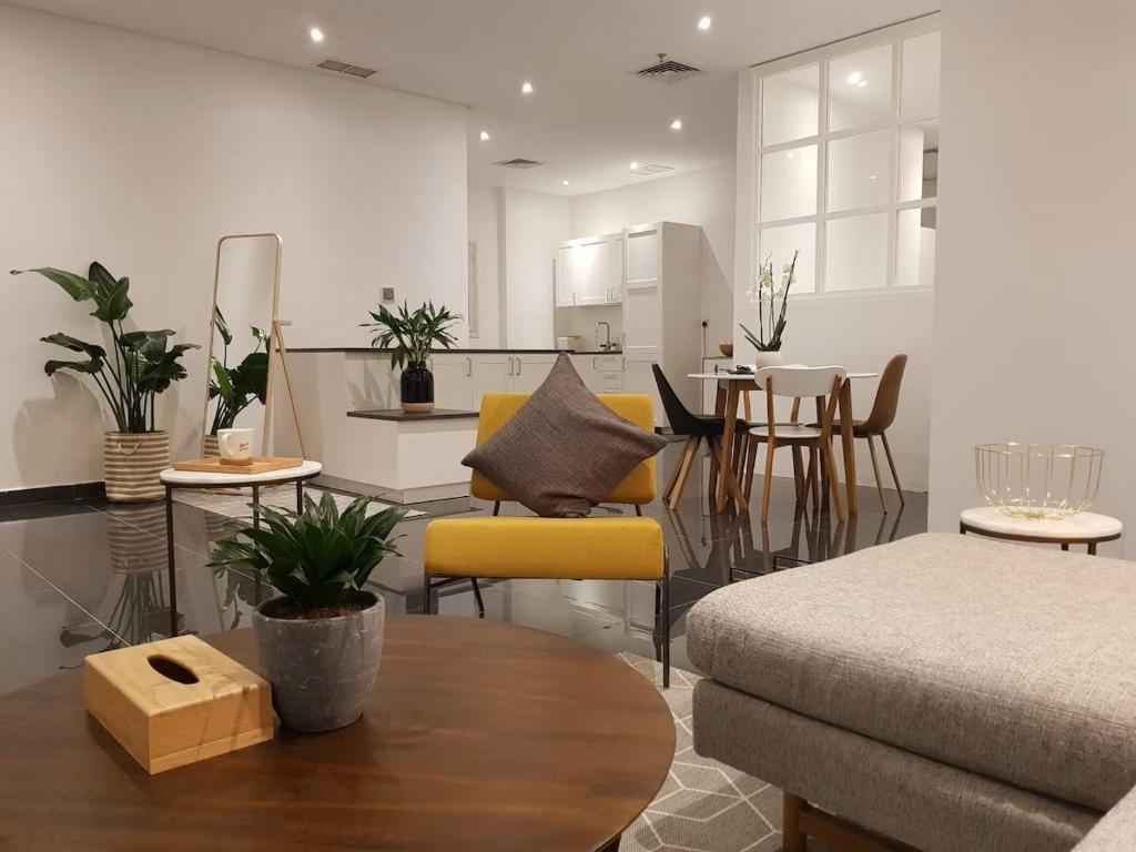 a living room with a couch and a table at Luxury Loft Apartment in Kuwait