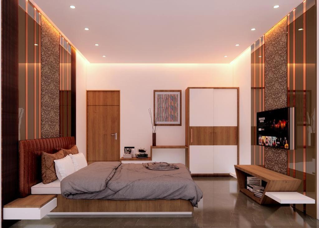 a bedroom with a bed and a television in it at The Mint Nanded Hotel in Nānded