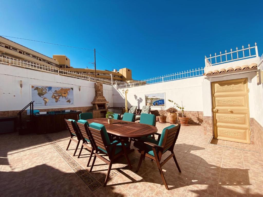 a table and chairs on a patio with a ship at The Good Life Holiday Home in Adeje