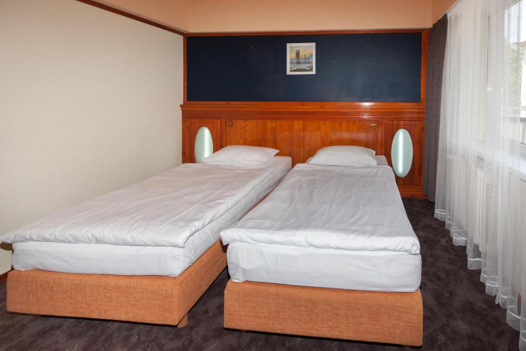 Lova arba lovos apgyvendinimo įstaigoje Tauras Center Hotel