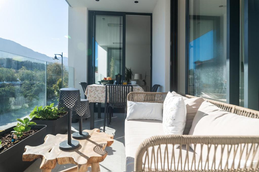 a patio with a couch and a table on a balcony at Riverview apartamento en LLanes in Llanes
