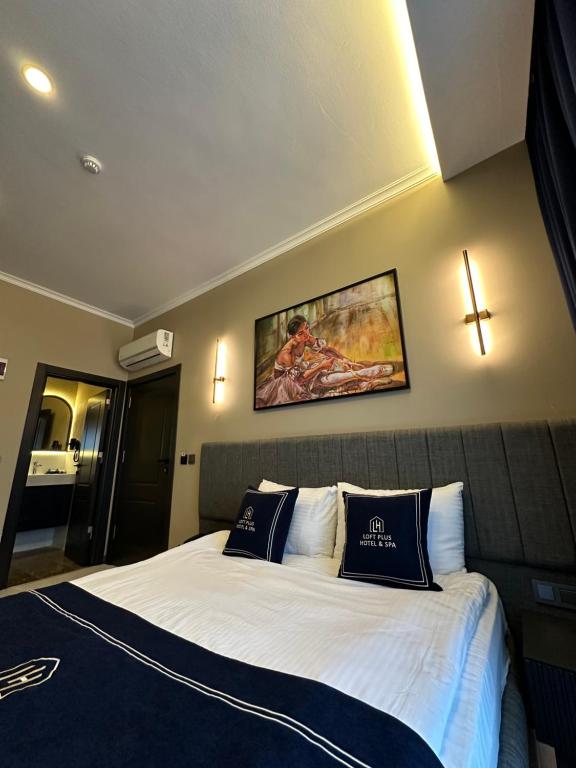 a hotel room with a large bed with two pillows at Loft Park Hotel's in Arnavutköy