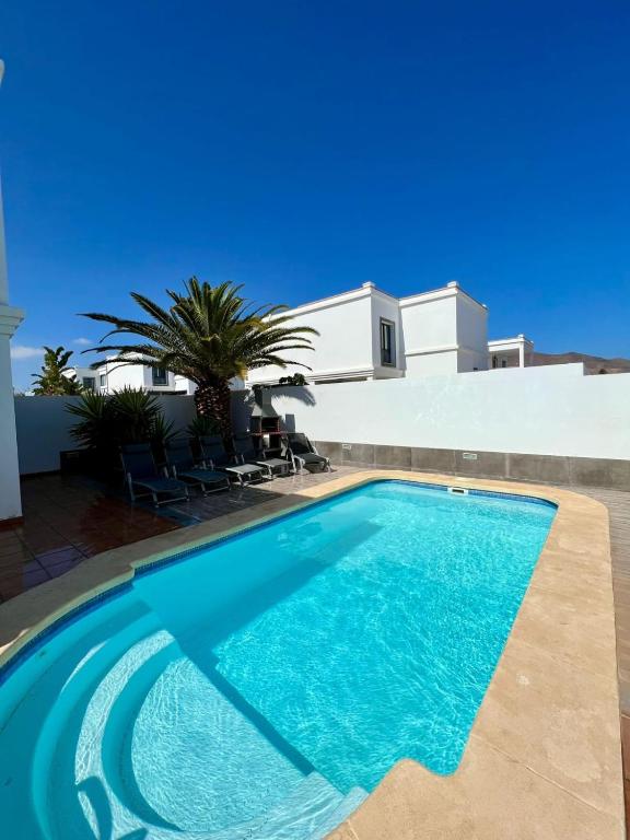 a swimming pool in front of a house at Villa Margherita in Playa Blanca