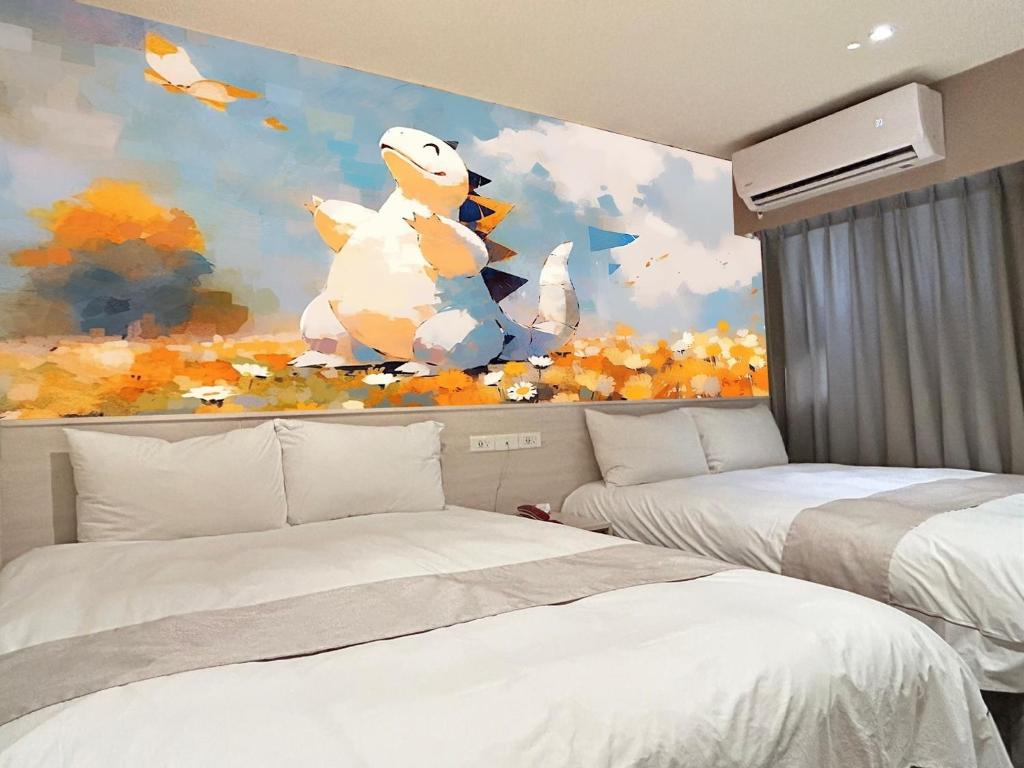 a bedroom with two beds and a painting at Dazz Inn in Taichung