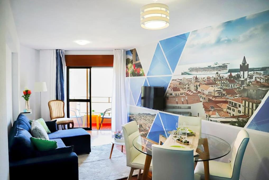 a living room with a mural of a city at Funchal downtown 5min Marina + 2 bedroom + parking in Funchal